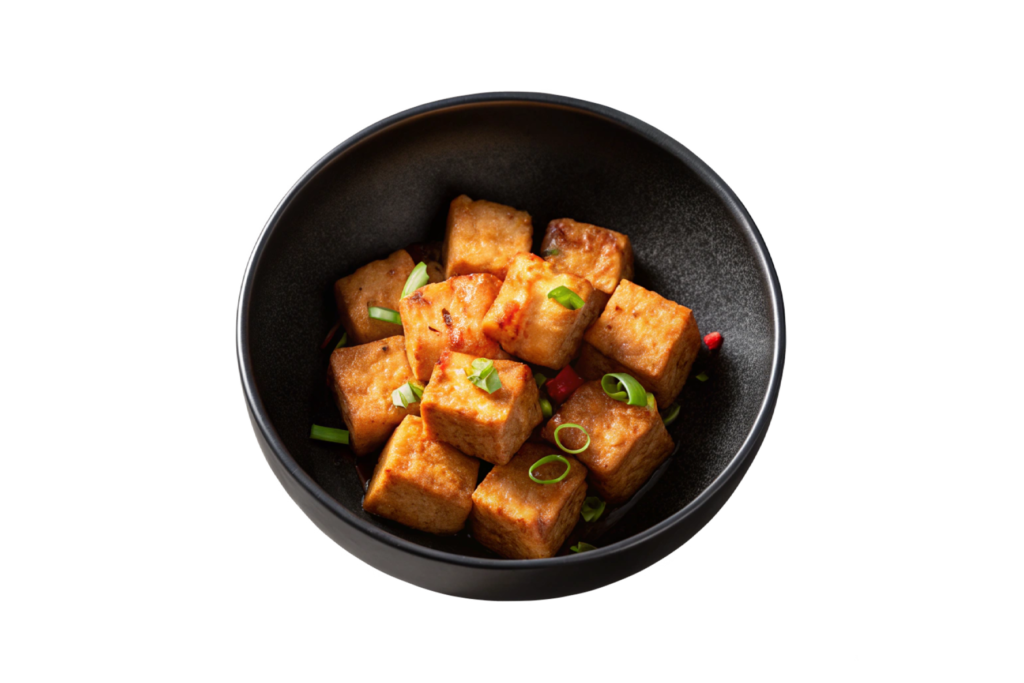 Bowl of spicy tofu cubes with garnish